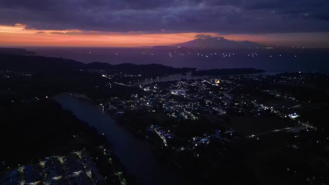 Slow pan evening sky darkening as night slowly arrives over the quiet village landscape of Maragondon Cavite Philippines.