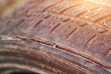 Damaged car tire with visible sidewall wear © AlexGo