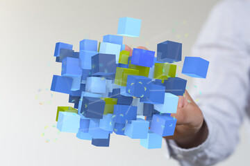 Obraz premium Abstract 3D cubes held in a hand, symbolizing technology, data, or innovation. Perfect for illustrating concepts of con