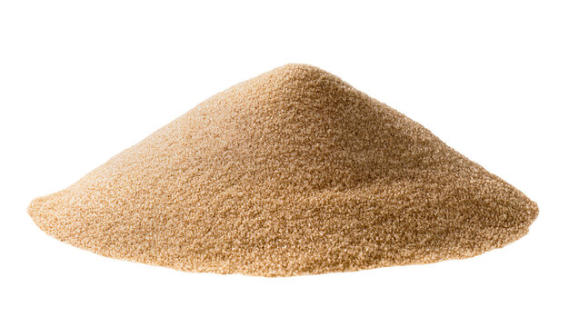 Isolated pyramid of fine granular brown sand or unrefined sugar forming a small textured heap