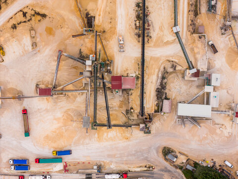 Aerial view of the industrial landscape, where earth tones meet the geometry of machinery and vehicles, Arsoli, Lazio, Italy.
