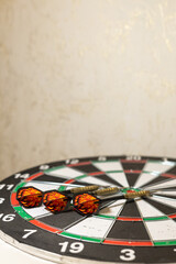 Obraz premium Three Darts Hitting Target on Classic Dartboard with Blurred Background