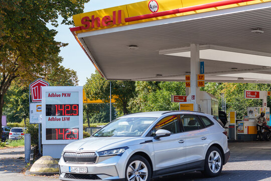Dusseldorf, Germany - September 6 2025: Modern SUV car leaving Shell petrol station sign displaying AdBlue fuel price board