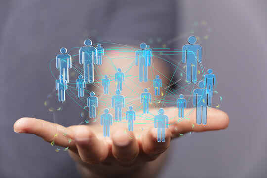 Hand holding interconnected human icons representing network, global business, teamwork, connection, community, and coll