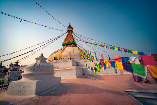 Majestic summer view of Boudha, bodhnath or Boudhanath stupa with prayer flags - biggest buddhist stupa. Colorful evening cityscape of Kathmandu, Nepal, Asia. Traveling concept background.