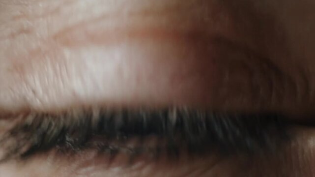 ultra-realistic human eye as the starting point, focusing tightly on the iris and cornea with detailed reflections of the city explosions.