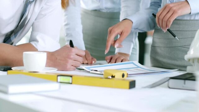 Architects and engineers team are working together to edit the draft building plan that was designed after it was presented to the client. architects and engineers work on blueprints for planning.