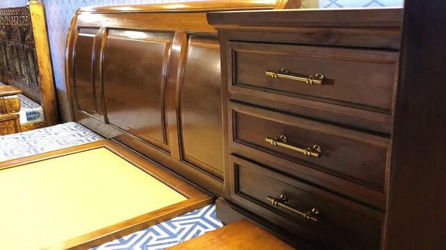 Wooden Bedside Cabinet with Golden Handles, A stylish wooden bedside cabinet with polished surface and golden handles.
