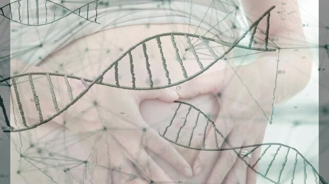 DNA overlay appearing hands forming heart over belly camera pulling back showing genetic connection