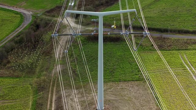 High angle aerial view of modern T-pylon electrical high voltage lines at the National Grid training facility in Eakring United Kingdom.