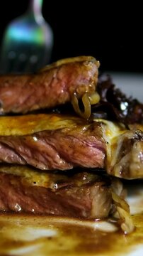 Close-up of a tender beef steak being picked up by a fork, revealing juicy, perfectly cooked interior. The rich texture and sizzling surface savory flavor. culinary videos. 