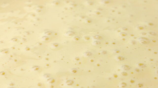 Active and bubbly sourdough starter batter for pancake circle rotation close up