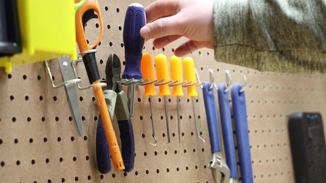 Organized Workshop Tools Displayed on Pegboard with Various Hand Tools