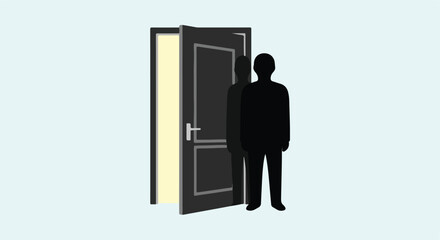 Fototapeta premium Silhouette of a person stands beside an open door with light glowing from within