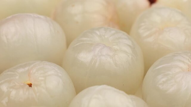 Peeled lychee pulp circle rotation close up