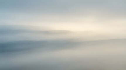 Fototapeta premium Soft diffused light filters through layers of fog creating an ethereal and serene atmospheric landscape at dawn or dusk
