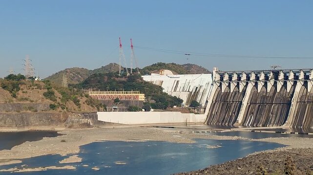 Sardar Sarovar Dam spillway on Narmada River near Statue of Unity, Kevadia, Gujarat, India. Large hydroelectric dam structure with reservoir and hills engineering, irrigation and energy production.