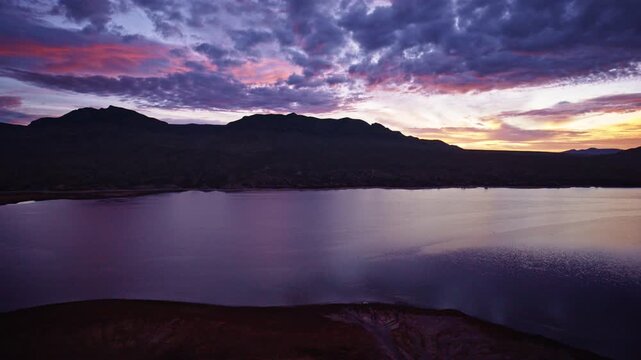 Cinematic drone view of glowing sunrise skies over Caballo Lake State Park, New Mexico.