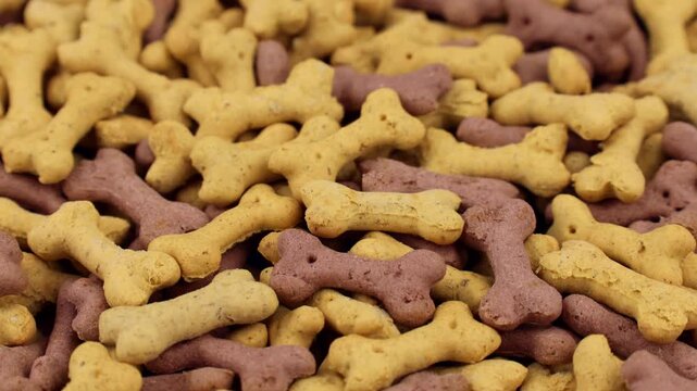 Brown dog food bone biscuits circle rotation close up top view