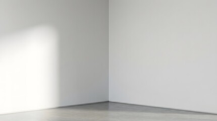 An empty interior corner of a modern room with white walls a concrete floor and subtle light and shadow play