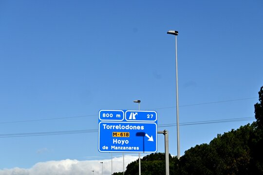 A road sign located on the M-40 motorway in Madrid, Spain, indicating exit 27 towards Torrelodones and Hoyo de Manzanares. March 15 . 2026