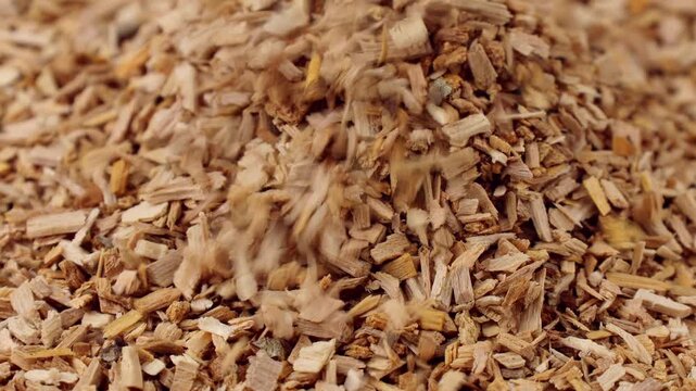 Wood alder smoking chips falling down close up