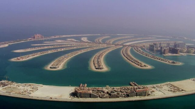 Aerial view of palm jumeirah island and dubai skyline at sunset. 