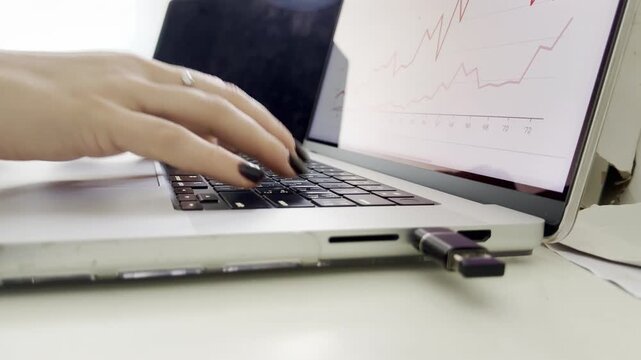 female hands typing on laptop keyboard for data analysis process