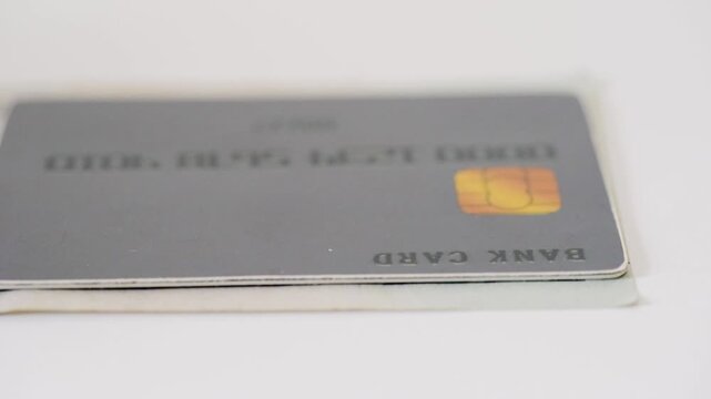 Closeup of card chip press. Pressing chip on card to confirm payment in detail. Detailed closeup image of finger applying slight pressure on card chip during transaction