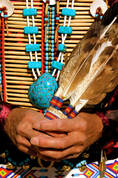 Okhay Owingeh Pueblo, New Mexico, United States. . Native man wearing bone breast plate and holding ceremonial  feathers.