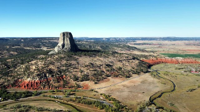 Aerial drone view of Devils Tower National Monument rising dramatically above the surrounding landscape in Wyoming, US