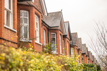 LONDON - Red brick Victorian terraced houses with bay windows in Ealing West London