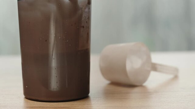 I'm whipping up a milk-protein shake with a blender, slow motion. I put the dirty blender on the table behind