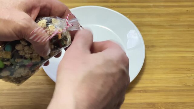 Untying twine on bag and pouring sweets from it
