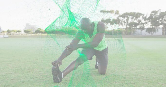 Kneeling during fitness session athlete doing hamstring stretch with green mesh accentuating motion