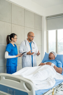 Doctor team visiting man cancer patient with care and compassion in hospital room. Oncology support medical consultation healthcare and hope. Doctor reporting medical test results to the patient