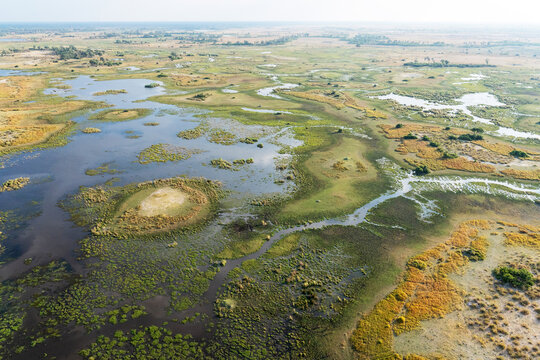 An aerial shot of a rather dry wetland in Okavango delta during an evening near Maun, Botswana