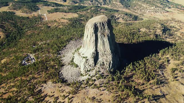 Aerial drone view of Devils Tower National Monument rising dramatically above the surrounding landscape in Wyoming, US