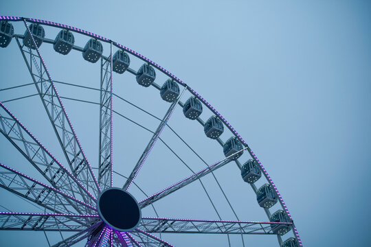 Ferris wheel against a clear blue sky with subtle lighting effects. Belgium
