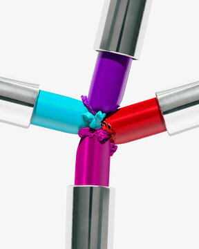 Four colorful lipstick tubes arranged in a symmetric cross pattern on a white background.