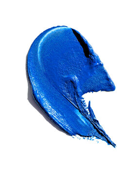 Swatch of bright blue creamy makeup or paint on a white background.