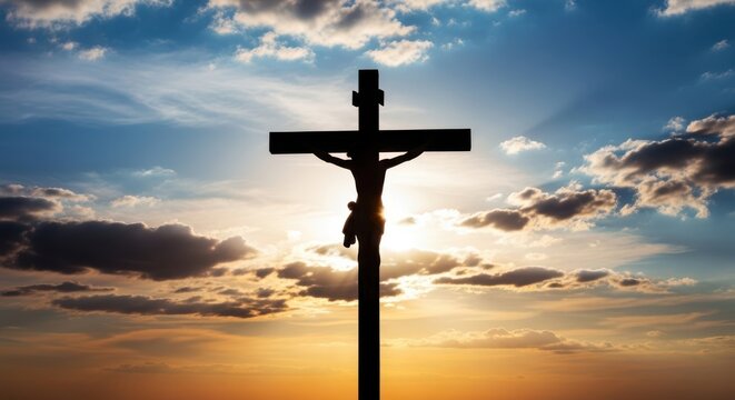 Crucifix with jesus christ on the cross at sunset with clouds in the sky