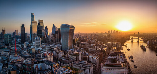 Panoramic aerial view of the City of London, UK, skyline during sunrise with office skyscrapers and river Thames © moofushi