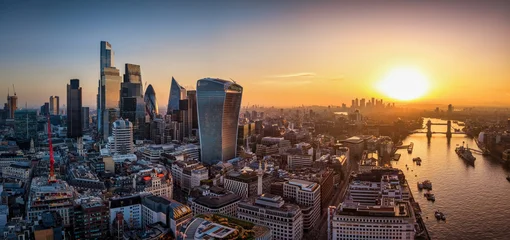 Fotobehang London Panoramic aerial view of the City of London, UK, skyline during sunrise with office skyscrapers and river Thames  © moofushi