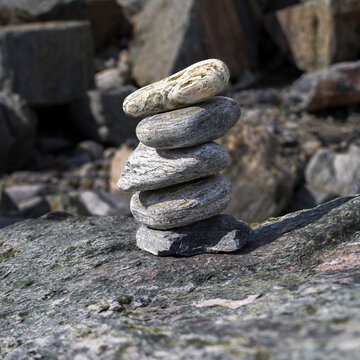 A balanced stack of smooth stones in a rocky natural landscape. La Paz, Baja California Sur, Mexico