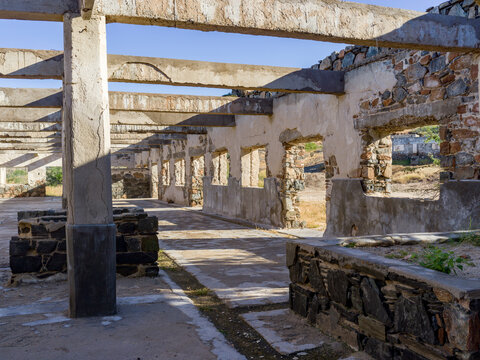 Sunlit ruins of an old stone building with exposed beams and partially collapsed walls. La Paz, Baja California Sur, Mexico