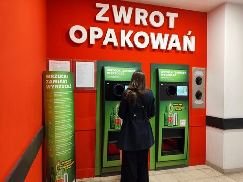 WARSAW, POLAND - FEBRUARY 28, 2026: Person returns plastic bottles at special recycling point in Kaufland grocery store in Poland.