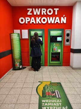 WARSAW, POLAND - FEBRUARY 28, 2026: Person returns plastic bottles at special recycling point in a grocery store in Poland.