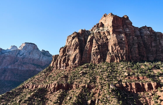 Majestic red rock cliffs and rugged landscapes under a clear blue sky. Zion National Park, Utah, USA