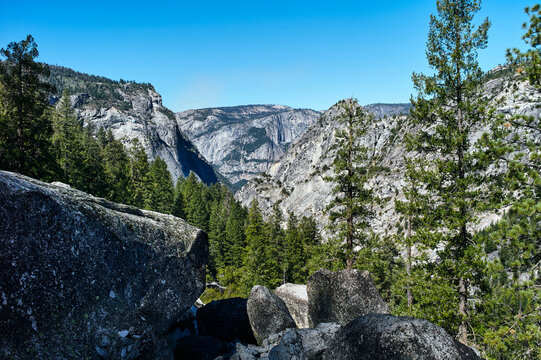 Majestic mountainous landscape with lush trees and clear blue sky. Yosemite National Park, California, USA